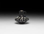 Islamic Ottoman Miniature Glass Jug
19th century AD. A black glass miniature jug with short neck and broad biconvex body, strap handle, applied runni...