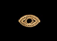Islamic Gold Necklace 'Eye' Element
10th-11th century AD. A gold bead or necklace element, eye-shaped in plan with twisted wire rims, body formed fro...