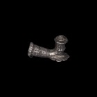 Islamic Silver Pipe
18th century AD. A silver pipe element with incised chevron and line decoration, scalloped plate and small suspension loop to the...
