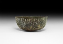 Islamic Calligraphic Bowl
13th-14th century AD. A broad bronze bowl with everted chamfered rim, band of reserved text below the rim on a hatched fiel...