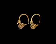 Islamic Gold Bird Earring Pair
19th century AD or earlier. A matched pair of gold earrings, each a thick wire hoop and filigree bird modelled in the ...