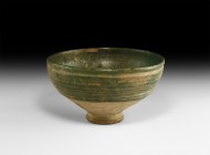 Islamic Green Glazed Bowl
13th century AD. A large green glazed footed bowl with sloping body and ribbed walls, thickened rim. 911 grams, 22cm diamet...
