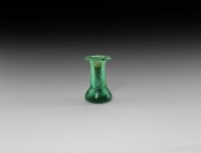 Islamic Green Glass Vessel
13th-14th century AD. A deep green glass vessel with flared base, tubular body with rolled rim. 172 grams, 84mm (8 1/4''")...