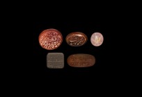 Islamic Calligraphic Gemstone Group
20th century AD. A mixed group of carnelian, agate and other stone plaques each with incised calligraphic text. 3...