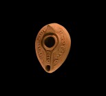 Islamic Epigraphic Oil Lamp
7th-9th century AD. A terracotta slipper-shaped oil lamp with cross and ring to the underside, broad shoulder with band o...