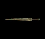 Western Asiatic Luristan Sword
13th-6th century BC. A bronze sword with triangular, lentoid section two-edged blade, long lower guard with strip exte...