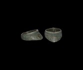 Roman Archer's Ring
1st-3rd century AD. A bronze archer's ring comprising a broad hoop with lobe to the underside, triangular flange with hatching an...