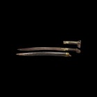 Post Medieval Yataghan Sword
Dated 1220 AH (1806 AD"). A sword with swept single-edged blade and scabbard; the blade with inlaid brass designs and ca...