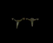 Roman Military Prick Spur Pair
3rd-4th century AD. A pair of bronze prick spurs comprising: one with round-section pricket, lateral attachment lobes ...