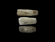 Neolithic Polished Axehead Group
5th-2nd millennium BC. A group of three knapped and polished stone axes with sheer sides, narrow butts and curved ed...