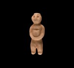 Neolithic Marble Standing Idol
3rd-2nd millennium BC. A marble figural idol of standing male with stubby legs, wearing a small cap, round head with h...