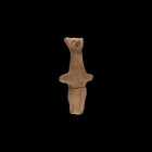 Vin?a Standing Idol
5th-4th millennium BC. A terracotta figurine with pinched facial features, stub arms and conjoined legs; vertical linear detailin...