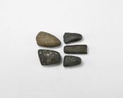 Neolithic Polished Axehead Collection
5th-3rd millennium BC. A mixed group of polished porphyry, diorite, and other stone axeheads, most with rounded...