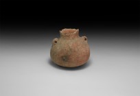 Bronze Age Holy Land Jar
2nd millennium BC. A squat terracotta jar with broad base, flared neck, two loop handles to the shoulder, painted wave patte...