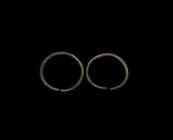Bronze Age Arm Ring Pair
3rd-2nd millennium BC. A pair of bronze penannular arm rings with round section shank and tapering finials. 215 grams total,...