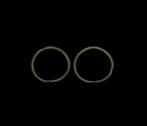 Bronze Age Arm Ring Pair
2nd millennium BC. A pair of round-section penannular arm rings with tapering finials. 225 grams total, 12cm (4 3/4"). Prope...