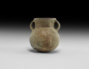 Bronze Age Holy Land Vessel with Handles
2nd millennium BC. A globular terracotta vessel with broad flared neck and two strap handles; band of impres...