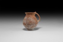 Bronze Age Single-Handled Jug
3rd-2nd millennium BC. A small terracotta jug with bulbous body, basal ring, flared neck with slot to rear, strap handl...