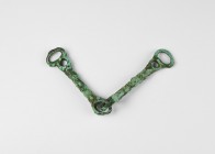 Bronze Age Horse Bit
2nd millennium BC. A bronze snaffle bit with four lines of raised decoration to each arm, double loop to each end. 121 grams, 22...
