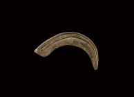 Bronze Age Scythe Blade
2nd-1st millennium BC. A bronze scythe blade with curving blade, flat ridge with rib running along the edge, short tang at th...
