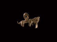 Iron Age Celtic Animal Pendant
2nd-1st century BC. A bronze pendant in the form of a dog(?) holding a disc in its mouth, hollow to the underside, tea...