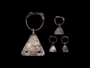Iron Age Celtic Silver Axe Pendant Group
3rd-1st century BC. A group of silver pendants comprising: three small sheet silver triangular breloques eac...