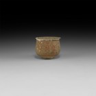 Iron Age Celtiberian Footed Cup with Figural Frieze
3rd-2nd century BC. A ceramic unglazed squat jar with narrow basal ring and gusseted rim, painted...