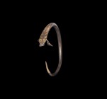 Iron Age Celtic Gilt Silver Bracelet with Axe Pendants
2nd-1st century BC. A silver penannular snake bracelet with round-section tapering shank, one ...