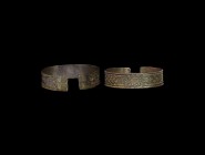 Viking Silver Decorated Bracelet
9th-12th century AD. A flat-section silver bracelet with reserved interlace band on a textured field, reserved knot ...