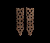 Viking Book Mount Pair
11th-12th century AD. A matched pair of bronze mounts, each a tongue-shaped panel with attachment pins, openwork body with rai...