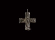 Viking Figural Cross Pendant
10th-11th century AD. A bronze pectoral cross with pierced lug above, raised linear borders enclosing a facing Corpus Ch...