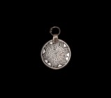 Viking Silver Inlaid Pendant
10th-12th century AD. A large bronze disc with applied strap and suspension loop, inlaid silver geometric design to obve...