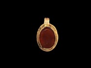 Saxon Gold and Carnelian Pendant
6th-7th century AD. A gold discoid pendant with ribbed loop and beaded border, cell with inset carnelian cloison. 3....