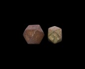 Viking Polyhedral Weight Group
9th-11th century AD. A group of two bronze polyhedral trade weights, the smaller with three impressed points to one fa...