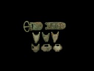 Viking Belt Mount Group
10th century AD. A mixed group of bronze belt fittings including chevron mounts, heart-shaped mounts, buckle with plate and t...