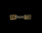 Anglo-Saxon Chip-Carved Mount
6th century AD. A gilt bronze mount with a plain central bar connecting two rectangular panels with chip-carved Salin's...