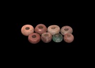 Viking Spindle Whorl Group
9th-11th century AD. A mixed group of discoid spindle whorls comprising: three in deep red limestone; three in light red l...