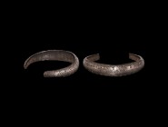 Viking Silver Bracelet with Stamped Design
9th-12th century AD. A silver C-section penannular bracelet with rounded ends, median band of stamped ring...