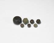 Viking Trade Weight Group
9th-11th century AD. A group of eight bronze weights comprising: a large barrel-shaped weight inscribed with 'AE' to both f...