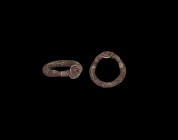 Viking Silver Plaited Ring
9th-11th century AD. A silver hoop divided into expanding rods and plaited tightly, the tapering ends twisted about the sh...
