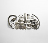 Viking Silver 'Hack' Group
10th-12th century AD. A mixed group of 'hack silver' including: fragments of stamped bracelet; two tongue-shaped tags; a f...