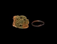 Viking Artefact Group
9th-11th century AD. A mixed bronze group comprising: a D-section finger ring with the ends twisted round the shank; a stirrup ...