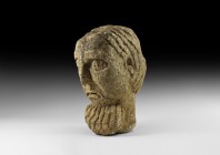 Medieval Architectural Gargoyle Head
12th-14th century AD. A carved stone protome architectural element formed as a square-section male head with pro...