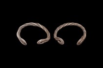 Medieval Silver 'Baniska Treasure' Type Twisted Bracelet Pair
13th century AD. A pair of silver bracelets formed from two hollow rods twisted about e...