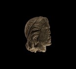 Medieval Bearded Head
13th-15th century AD. A hollow-formed bronze male head with beard and flowing hair, headband with hole to the reverse to accept...