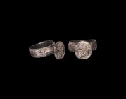 Medieval Silver Ring with Dragon
15th century AD. A silver ring with flat-section hoop, teardrop panels to the shoulders, trumpet-shaped bezel, the p...