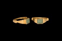 Medieval Gold Ring with Peridot Gemstone
14th century AD or earlier. A gold finger ring comprising a D-section tapering hoop with stepped shoulders, ...