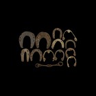 Medieval Horse Shoe and Bit Group
13th-15th century AD. A mixed group of iron furniture comprising: a snaffle-bit with attachment loops; ten small ho...
