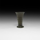 Medieval Bronze Flared Measure
12th-15th century AD. A bronze vessel with discoid base, flared body with stepped bands, chamfered rim. 138 grams, 81m...