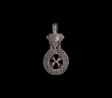 Medieval Face and Cross Pendant
12th-15th century AD. A silver pendant with integral loop, facing crowned bust of possibly St. Catherine above a spok...